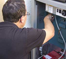 An MA Heating engineer working on a floor-standing boiler